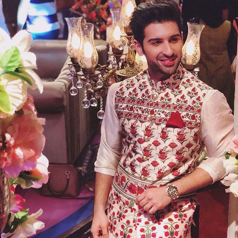 Picture of MUNEEB BUTT SPOTTED WEARING A SIGNATURE NOMI ANSARI TAILORED WAIST COAT PAIRED WITH A SILK KURTA
