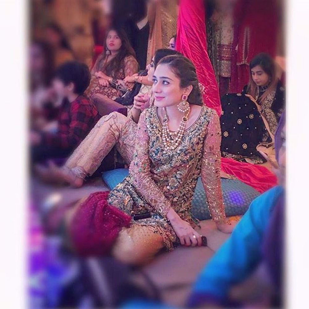 Picture of Maham Faraz spotted in an #emerald jeweled embroidered shirt paired with a #saffron tulle net Dhaka pyjama and a #magenta dupatta at a wedding in karachi