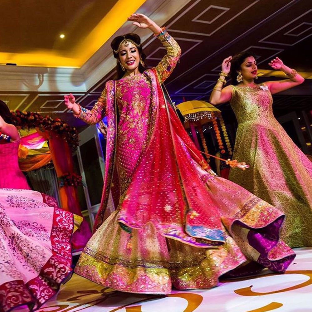 Picture of Rakhshan Butt in our traditional #hotPink Kamiz paired with a regal Farshi gharara and #Coral dupatta at her wedding reception in #Nairobi #Kenya