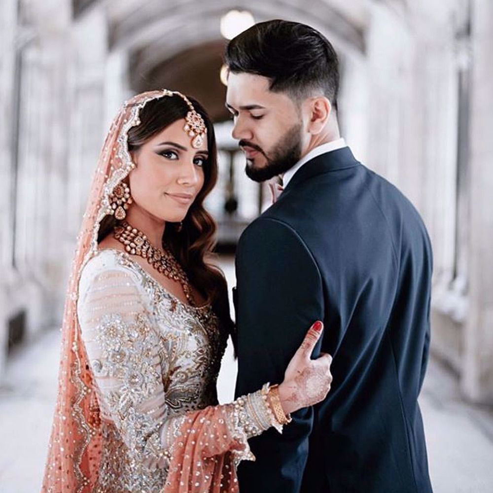Picture of Shahbakht and Dawar at their wedding reception  pretty bride Shahbakht wears a Ganga Jamni heavily embroidered Anarkali paired with a peach scallop dupatta and a banarsi lehenga.