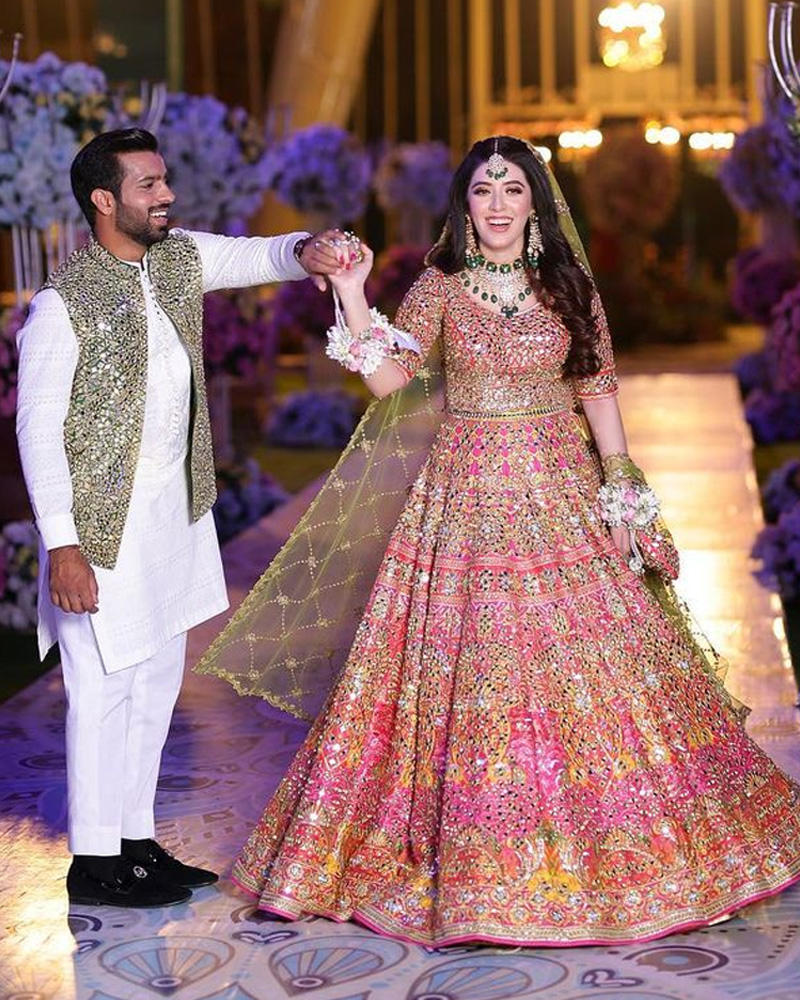Picture of A beautiful burst of colours and mirrorwork for Aima and Haseeb’s coordinating mayun looks.