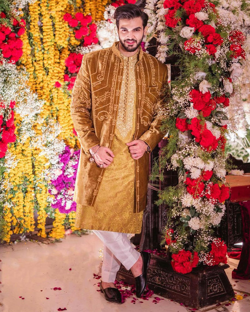 Picture of Akbar wears a bespoke velvet jacket with gold handwork, complimented by a smart kurta with matching embroidered detailing.